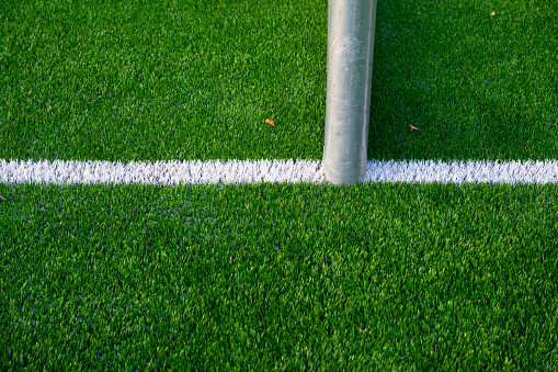 White markings and goal post of an artificial turf football field