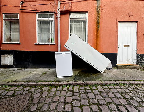 Two refrigerators stocked on a street outside a house. February 2024