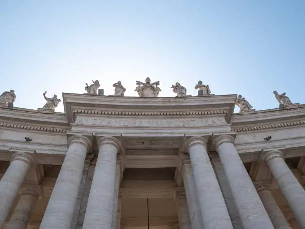 Statues of saints and apostles on colonnade of St. Peter's basilica, Vatican city, Italy. Horizontal view.