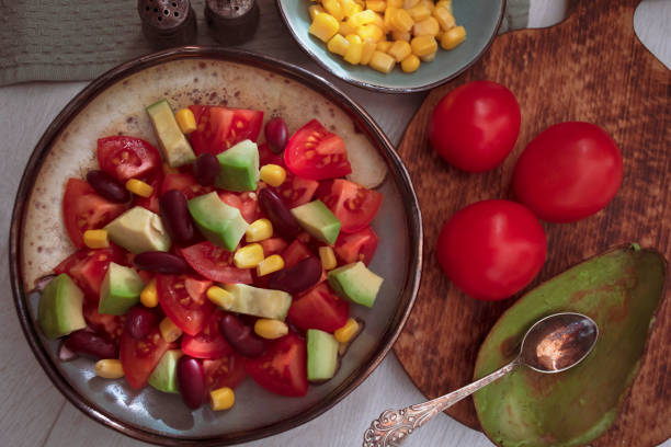 Corn salad tomato fresh vegetables snack fresh delicious gourmet food background on the table  rustic food top view copy space keto and paleo diet vegetarian and vegan food