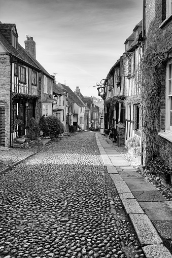 A monochrome view of the old Mermaid Inn in the cobbled Mermaid Street of Rye in East Sussex England UK