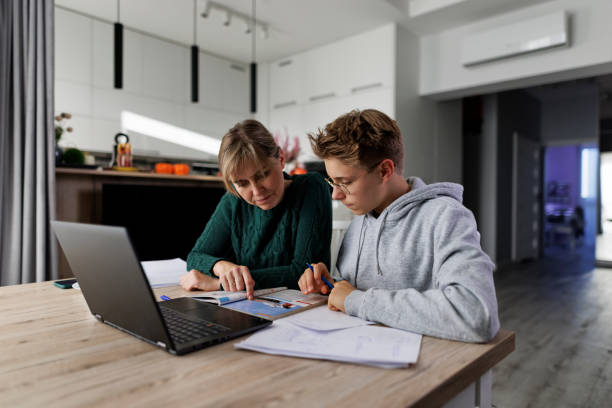 istock Mother helping son with some homework 1982627066