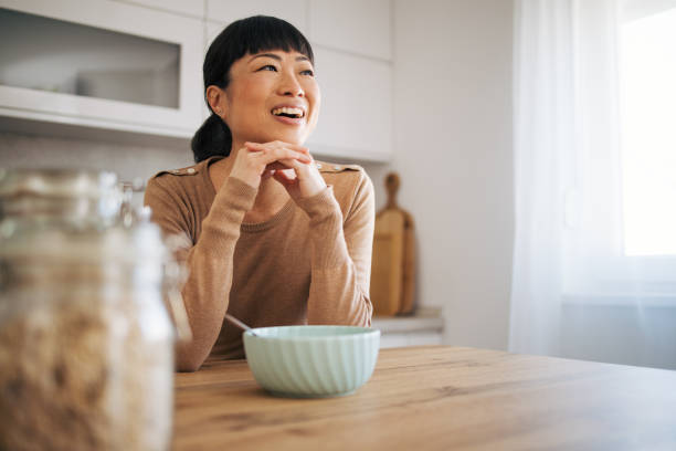 istock Japanese middle age woman day dreaming at the kitchen 1982629247