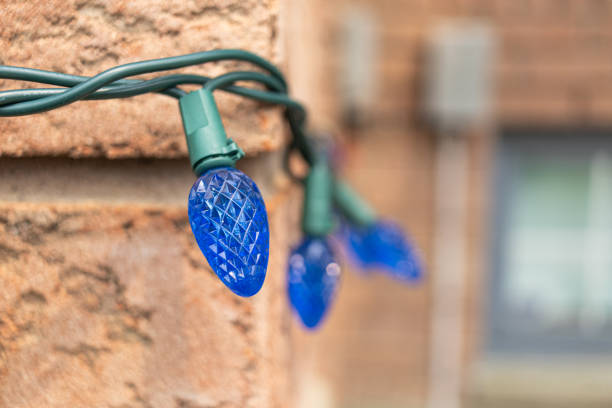 Blue Christmas lights on a brick wall - intricate patterns - festive ambiance