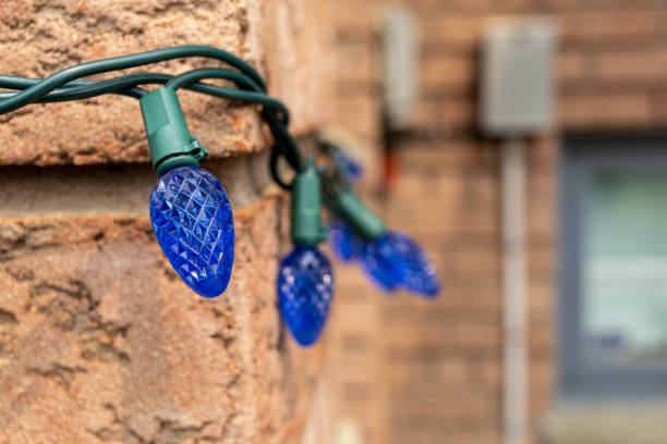 istock Blue Christmas lights on a brick wall - intricate patterns - festive ambiance 1982629324