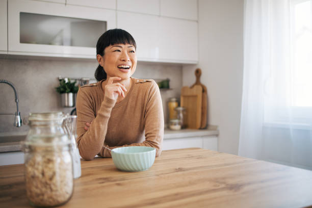 istock Japanese woman at kitchen smiling 1982629346