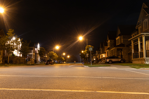 Empty parking lot lit by street lights.