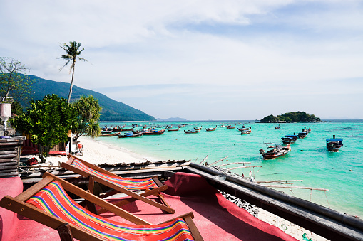 Beautiful sea, Tropical Turquoise clear blue sea and white sand beach with long tail boats at Lipe Island Satun Thailand.