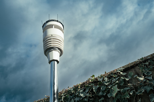 Advanced weather and climate sensor barrage showing ultrasonic wind sensors together temperature, humidity and haptic rain sensor. Seen with fitted bird spikes on its roof.