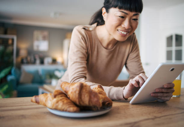 istock Japanese middle age woman using digital tablet 1982640663