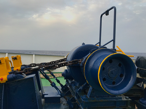 View of the capstan and anchor chain of an old ship at sea