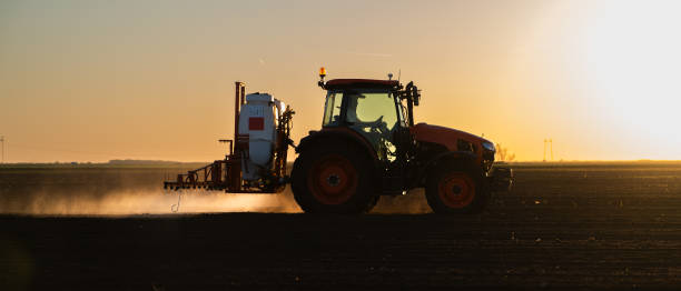 istock Tractor spraying soybean crops field 1982668643