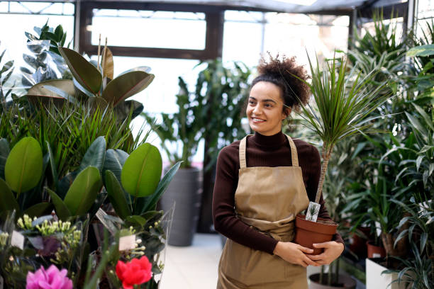 istock Young woman working in a garden center 1982680501