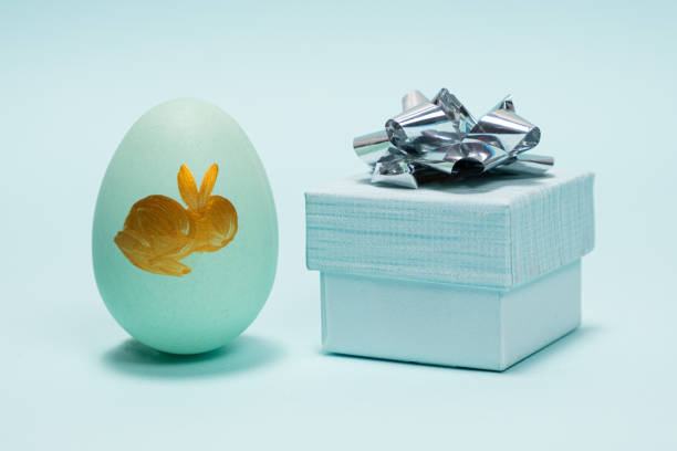 Easter Sale, Colored Egg With Rabbit Image And Gift Box With Big Bow On Blue Background
