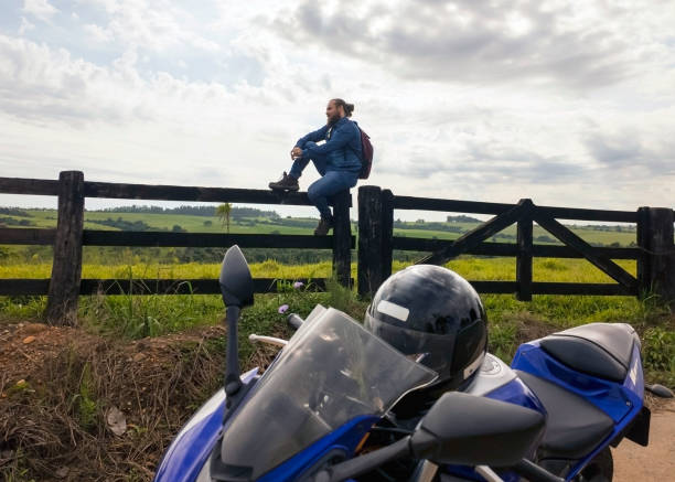 istock Man and his motorcycle in a rural place. 1982715595