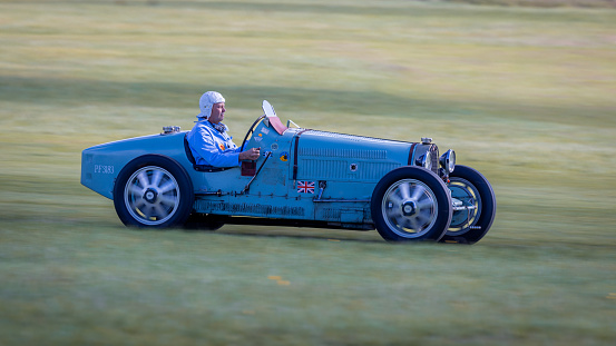 old Warden, UK - 2nd October 2022:  Vintage car Bugatti Type 51 being driven at speed along a grass runway