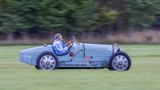 old Warden, UK - 2nd October 2022:  Vintage car Bugatti Type 51 being driven at speed along a grass runway
