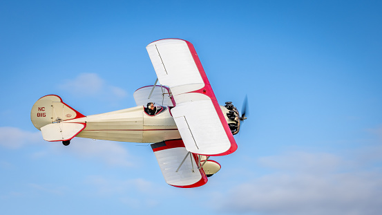 old Warden, UK - 2nd October 2022: Vintage aircraft Curtiss wright travel air 4000 flies close to the ground