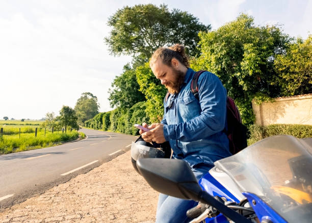 istock Man and his motorcycle in a rural place. 1982719814