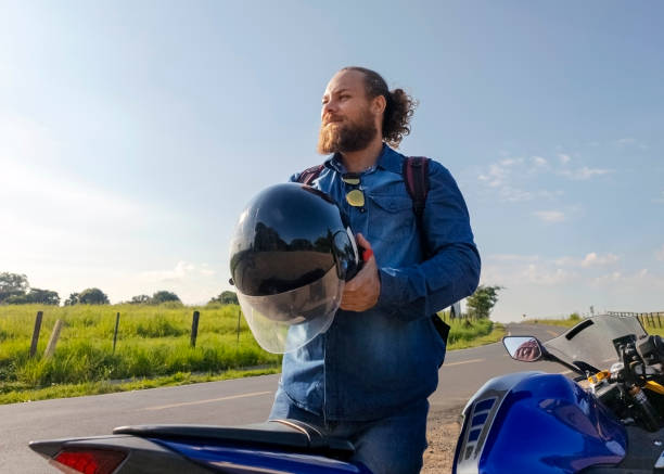 istock Man and his motorcycle in a rural place. 1982719821