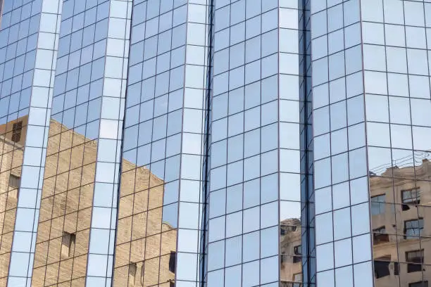 Reflections on a glass high rise building in the city