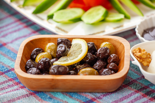 Olive Plate with sliced lemon on Breakfast Table.