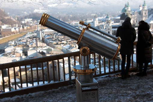Salzburg, Austria - 01.13.2024: Telescope on the walls of the Hohensalzburg fortress overlooking the Old Town.