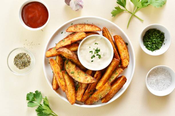 istock Oven baked potato wedges with sauce 1982883049