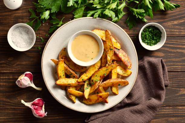 istock Baked potato wedges with sauce 1982883050
