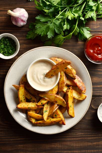 istock Baked potato wedges with sauce 1982883381