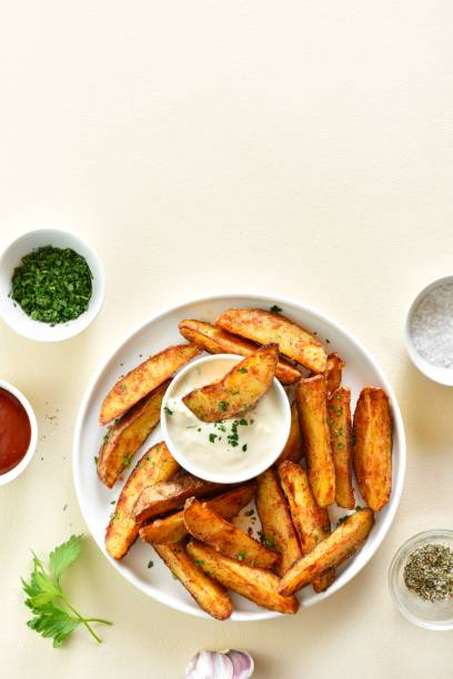 istock Oven baked potato wedges with sauce 1982883553