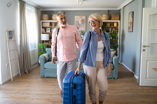 A Family with grandparents and grandson are going on vacation