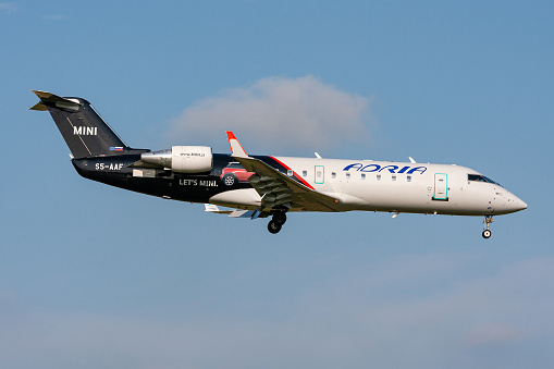 Schiphol, Netherlands - August 10, 2009: Slovenian Adria Airways Bombardier CRJ200 with registration S5-AAF in special Mini livery on final for Amsterdam Airport Schiphol