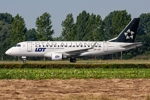Hoofddorp, Netherlands - August 4, 2009: Polish LOT Embraer ERJ-170 with registration SP-LDK in Star Alliance livery rolling on taxiway V of Amsterdam Airport Schiphol