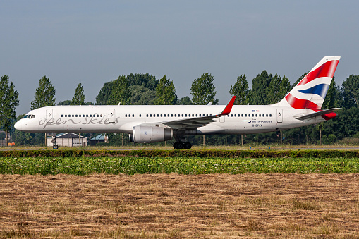 Hoofddorp, Netherlands - August 4, 2009: British Open Skies Boeing 757-200 with registration G-BPEK rolling on taxiway V of Amsterdam Airport Schiphol