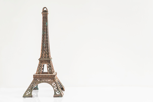 The Eiffel Tower toy on a white background; copy space
