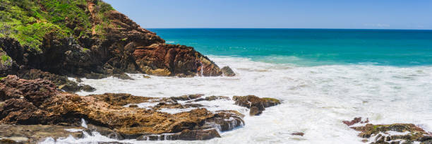istock Australian coast with volcanic rocks at the shore, view from the cliff on the seaside landscape. Strongly foamy water in windy weather, waves breaking on the rocks. 1982932252
