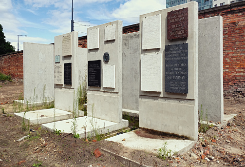 Warsaw, Poland - August 7, 2023. Commemorative plaques on the wall of Jewish cemetery at Okopowa Street, Warsaw, Poland