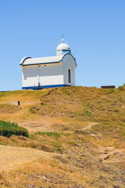 istock Port Macquarie Lighthouse, white lighthouse on the cliff top, seaside landscape on a summer sunny day. 1982977298