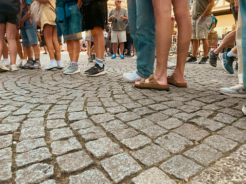 Strasbourg, France, Europe, July 20, 2023, Street level views of tourists lining up to enter the Strasbourg Cathedral Notre Dame. View from the waist down. Charming cobblestone streets.