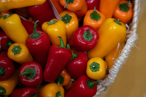 yellow and red chili peppers in a basket