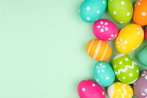 istock Colorful Easter Egg side border over a soft green paper background 1983052525