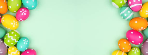 istock Colorful Easter Egg double border over a soft green paper banner background 1983052876
