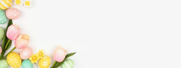 istock Easter eggs and flower decoration corner border against a white banner background 1983055662