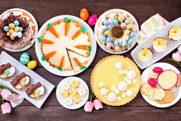 istock Easter or spring dessert food table scene. Overhead view over a dark wood background. 1983056720