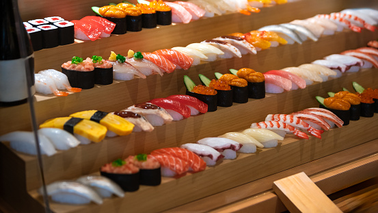 A captivating display of artificial sushi, skillfully rendered as sampuru, beckons diners to savor the visual feast before embarking on a culinary journey of authentic Japanese flavors