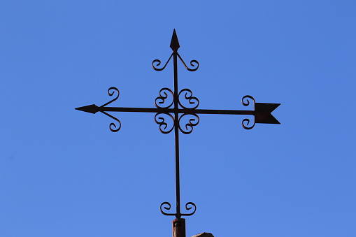 metal weather vane indicating wind direction