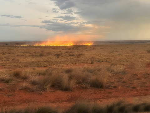 A grass or prairie fire rages in the desert scrubland near Ihorombe, Madagascar