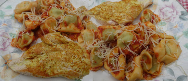istock Cooked and spicy turkey escalopes served with tortellini pasta 1983123329