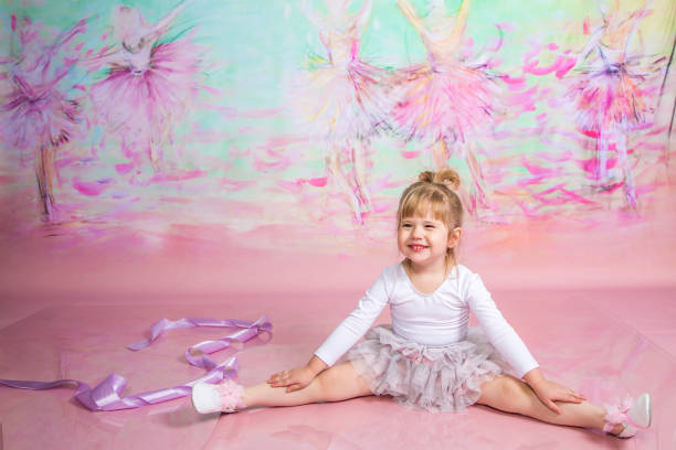 istock Cute Little Ballerina Doing Exercises Set in the studio 1983159820